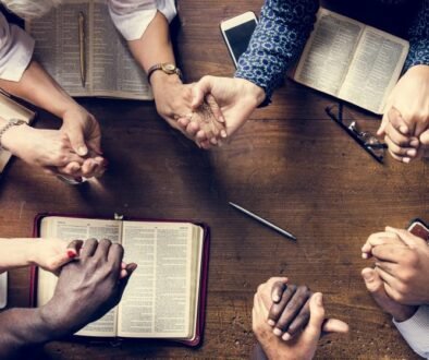 Group of people holding hands praying worship believe